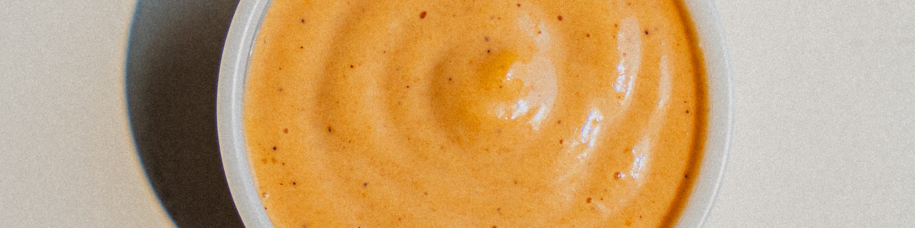 A cup of Goldies house-made gold sauce, seen from above